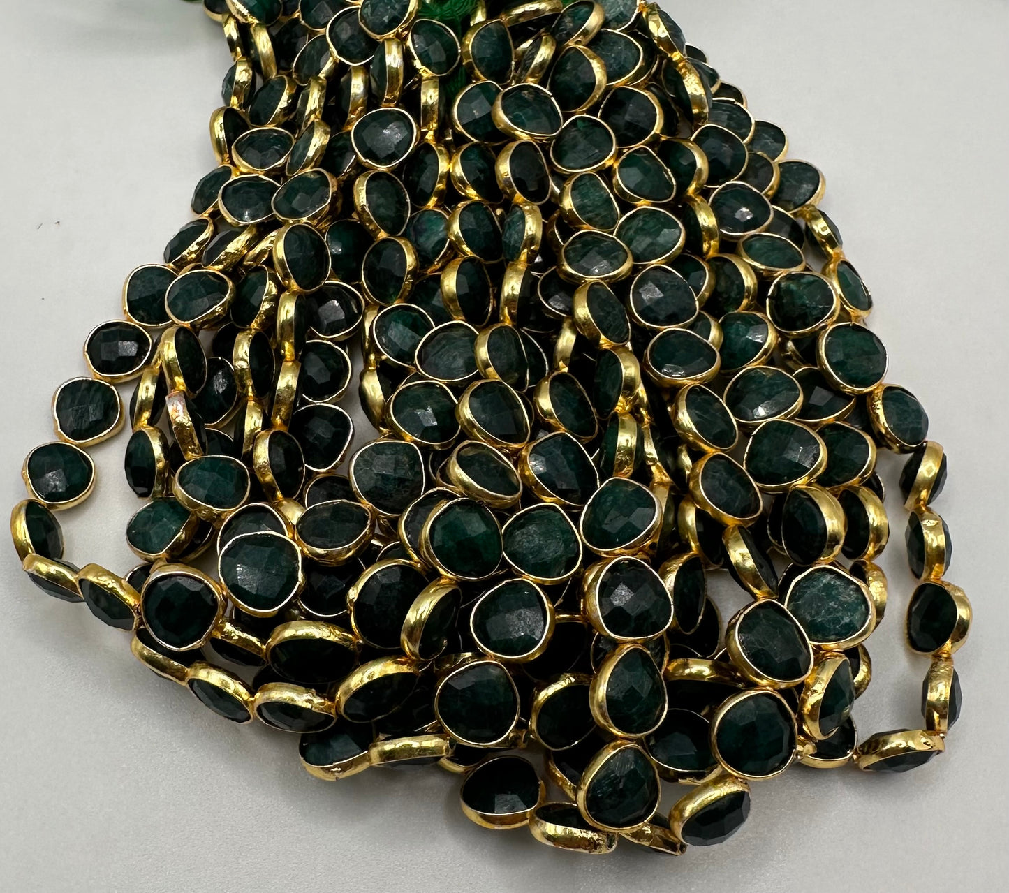 Emerald facetted heart 7mm bezel.