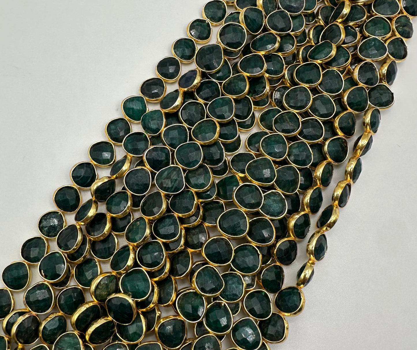 Emerald facetted heart 7mm bezel.