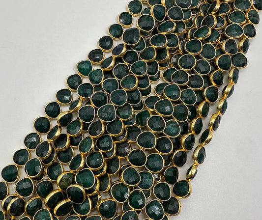 Emerald facetted heart 7mm bezel.