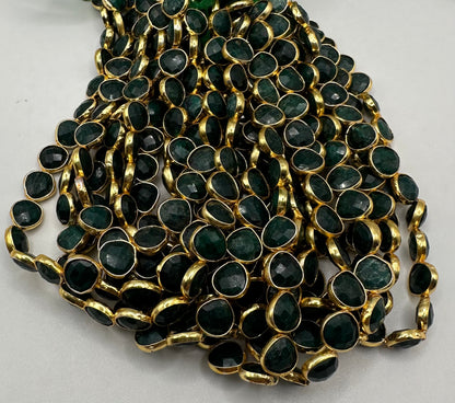 Emerald facetted heart 7mm bezel.